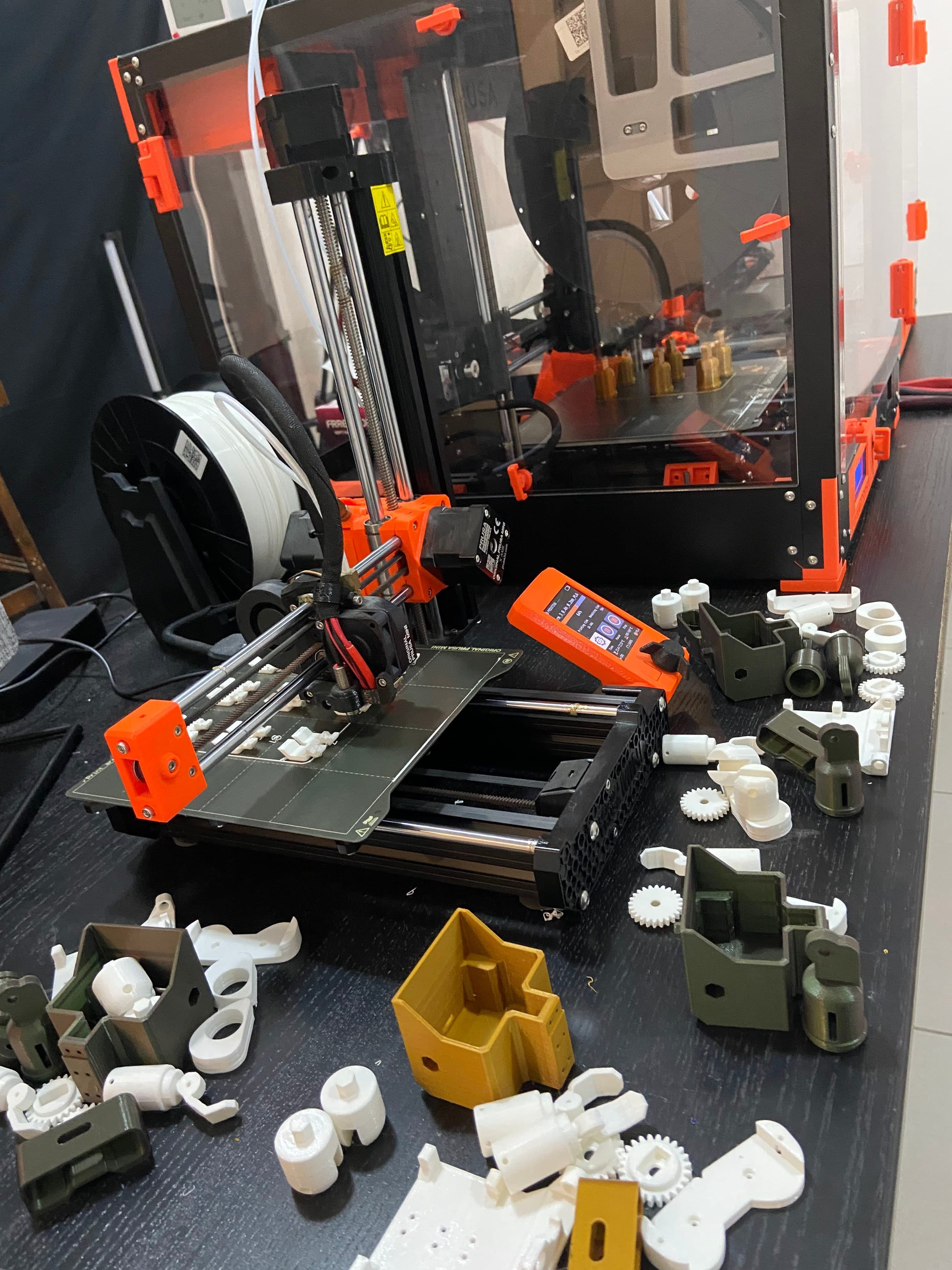 3D printed robot parts and tools on a fabrication bench