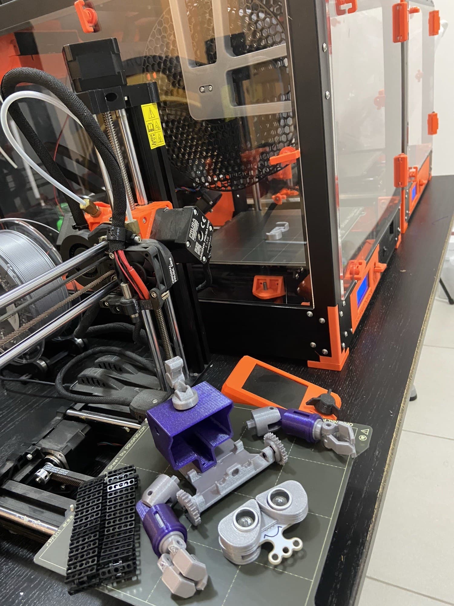 3D printed robot parts and tools on a fabrication bench